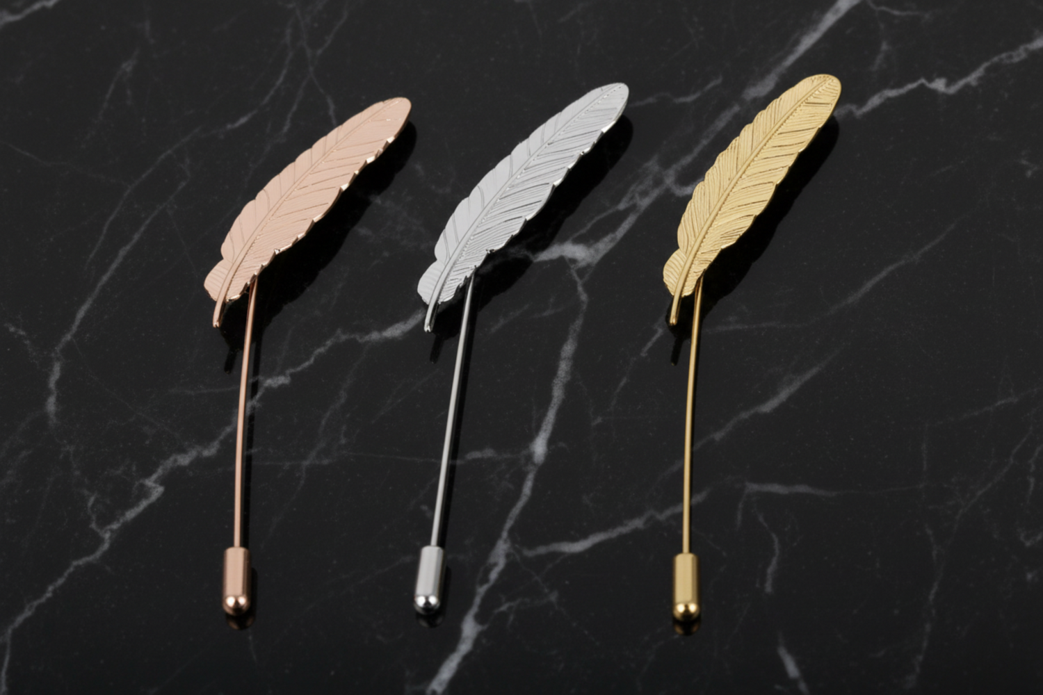 View 2: Three Feather Shaped Lapel Pins in Gold, Rose Gold and Silver Colors
