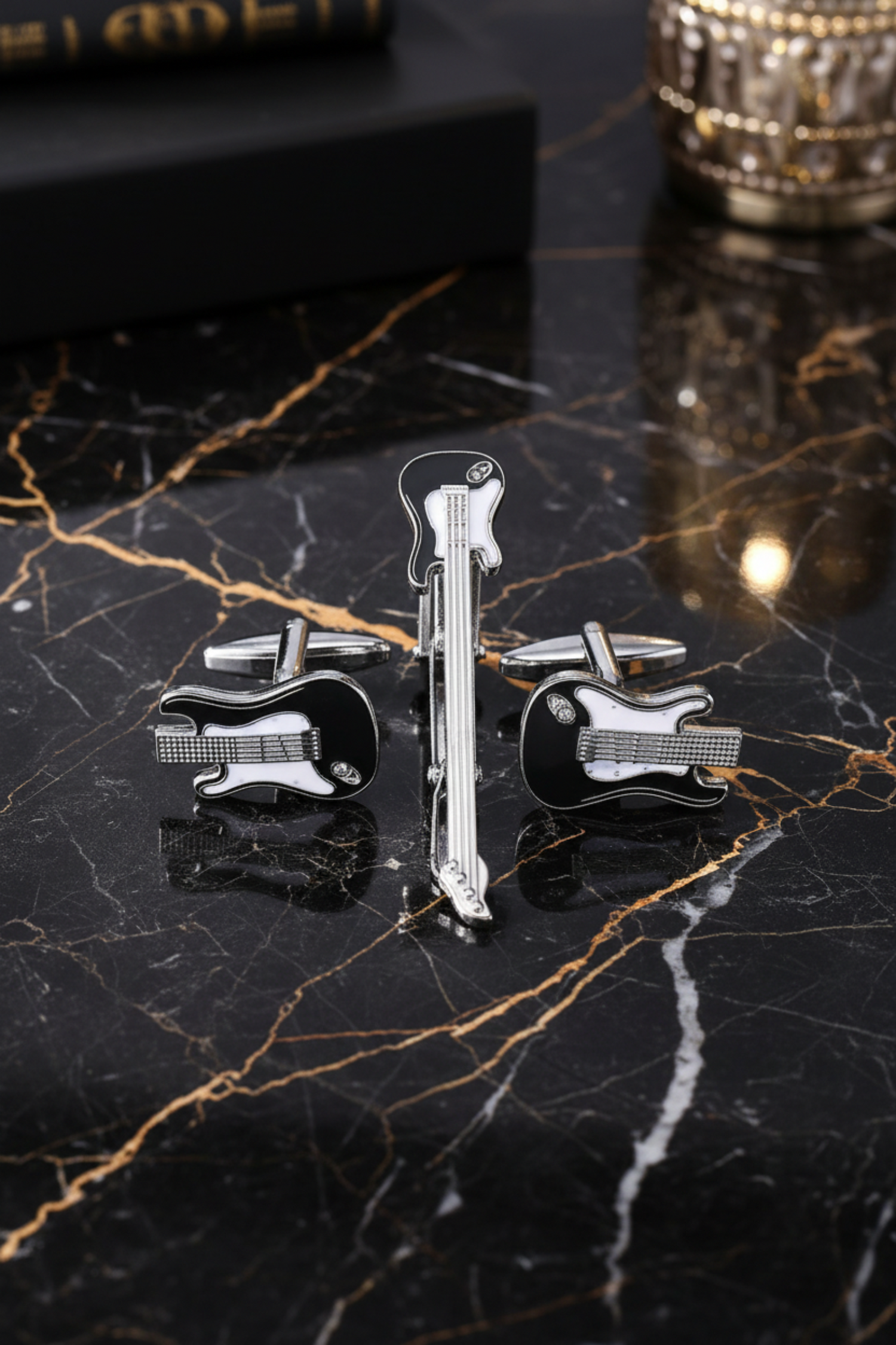 A Chrome, Black, White Colored Guitar Shaped Tie Bar, Cuff-links Set